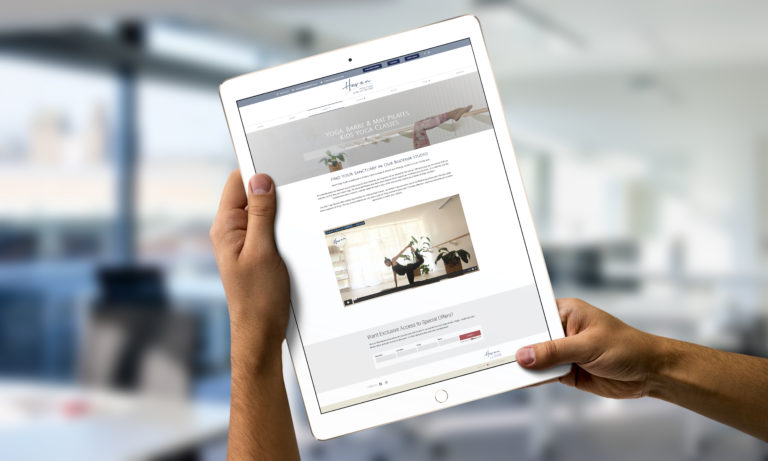 Person holding up a tablet with a website on the screen