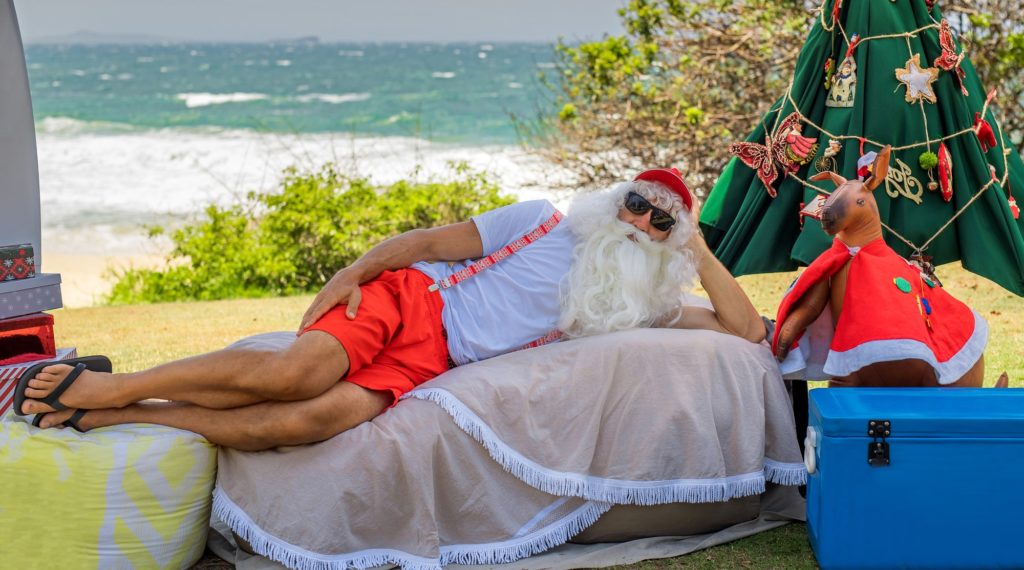 Relaxed Santa Claus lying on the beach