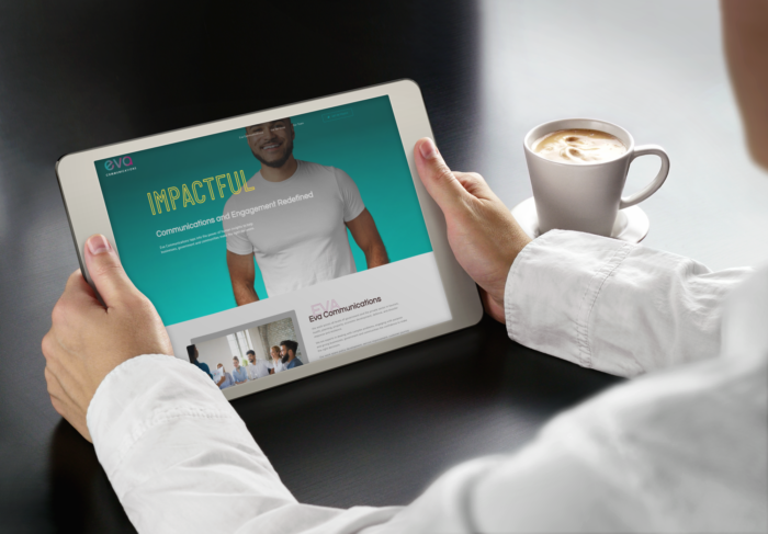 Person holding a tablet with a cup of coffee