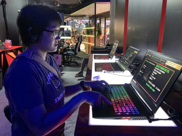 A woman at a gaming computer store checking the pc specifics.