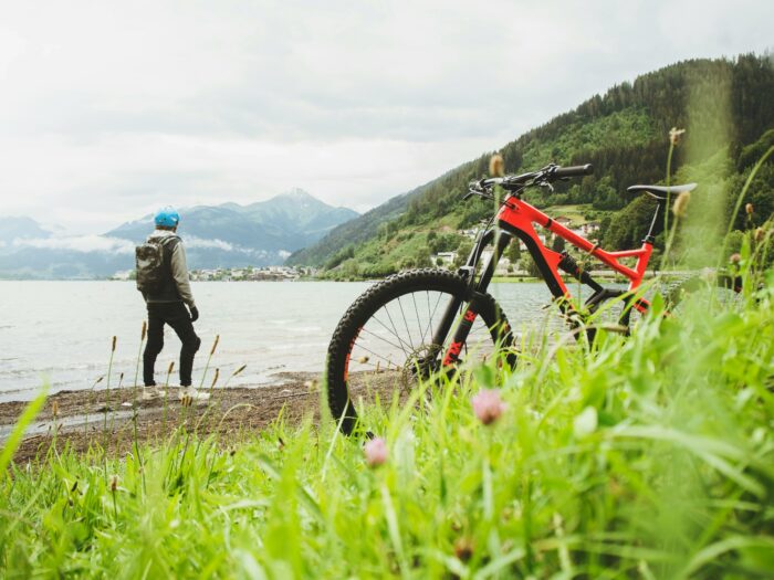 Man standing next to a bike on a beach