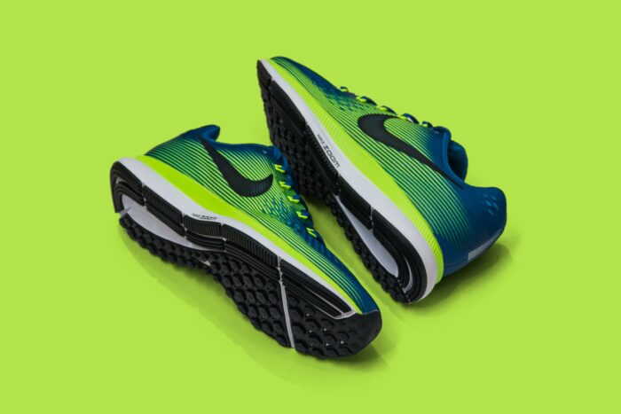 Pair of running shoes on a green background