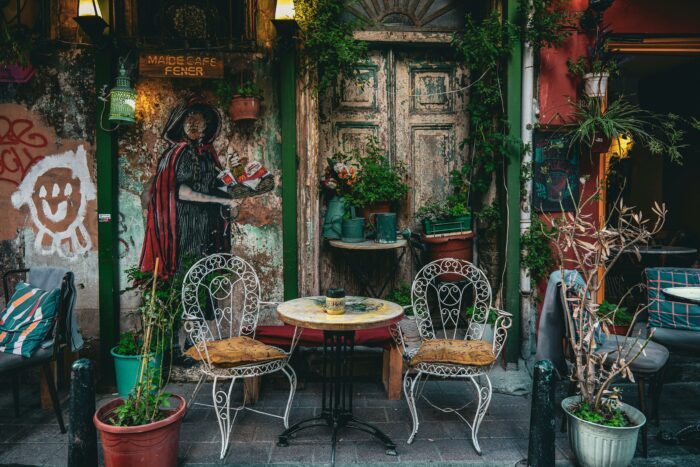 Woman sitting at a table in an outdoor cafe