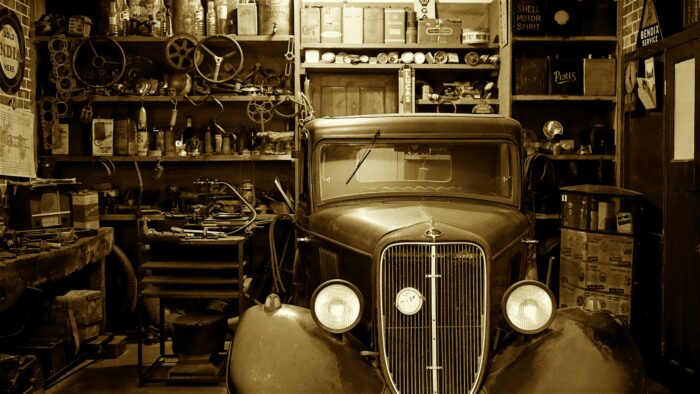 Black and white photo of a car in a garage