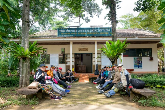 Group of people sitting on benches in front of a building