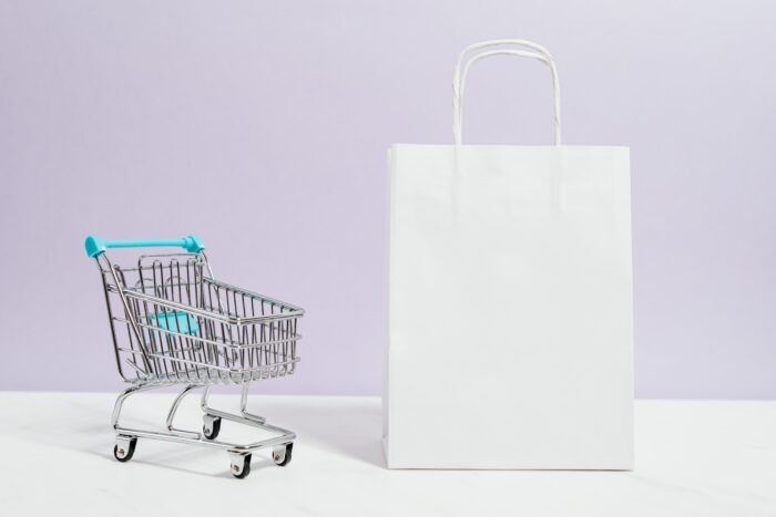 Shopping cart next to a shopping bag