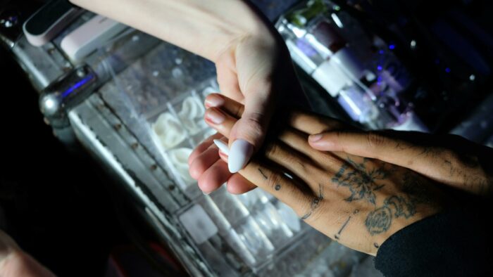 Person holding a cigarette in their hand