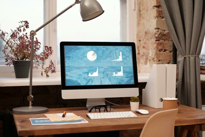 Computer sitting on top of a wooden desk