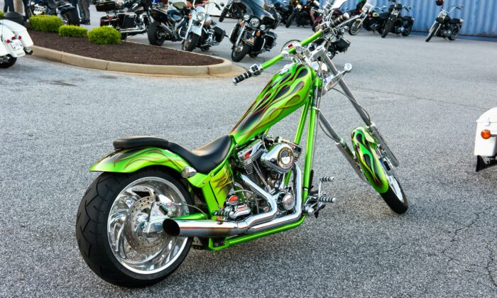 Green and black motorcycle parked in a parking lot
