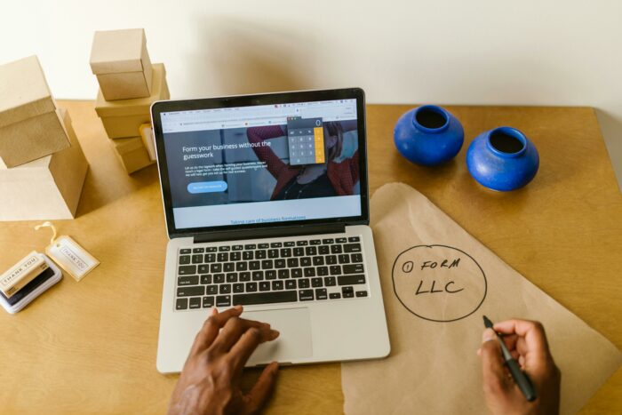Person sitting at a table with a laptop