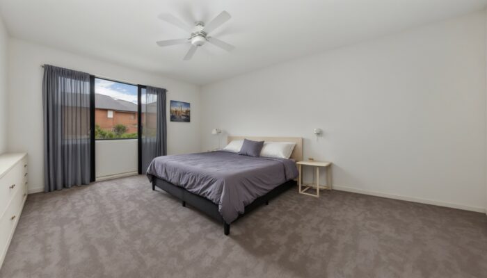 Bedroom with a bed and a ceiling fan