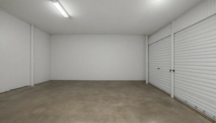 White storage room with a door open
