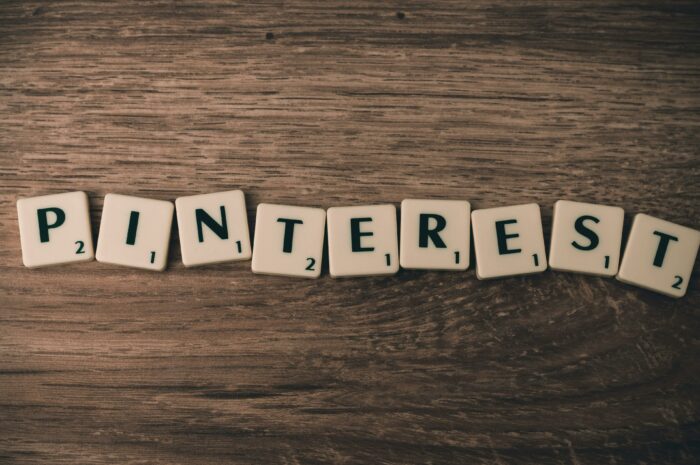 Word pinterist spelled with dice on a wooden table