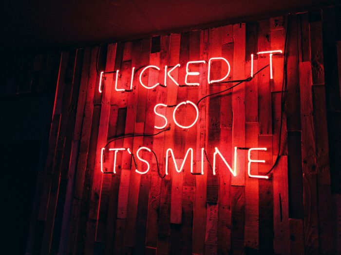 Neon sign that reads, ' locked to divine '