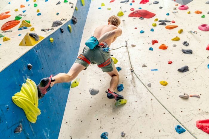applying magnesium to the hands from the bag before climbing the climbing wall