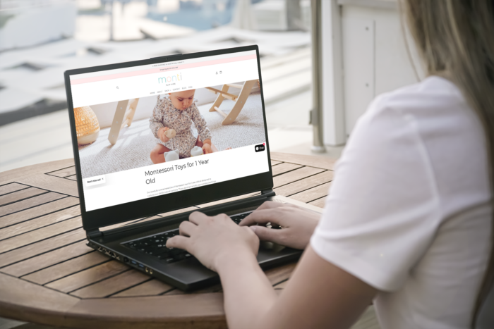 Woman sitting at a table with a laptop