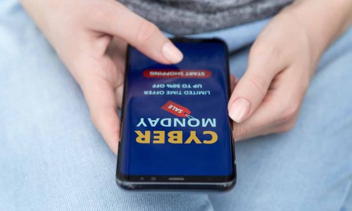 Female hands with a phone on the screen of which an advertisement for shopping online Female hands with a phone on the screen of which an advertisement for shopping online