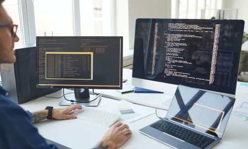 IT Programmer Writing Code on Computer Screen IT Programmer Writing Code on Computer Screen