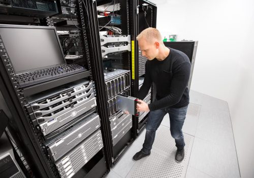 IT Technician Installing Blade Server In Chassis At Datacenter