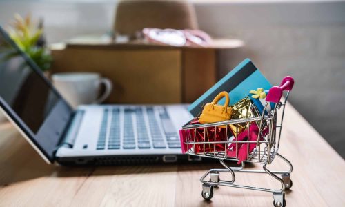 Shopping cart with credit card and woman accessories with laptop, Online shopping concept